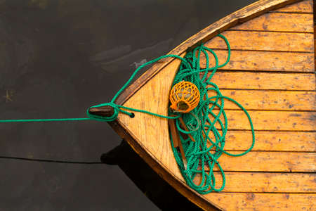 Fisherman boat with ropes and float. Norway. Wooden boat made fast to the pier.の写真素材