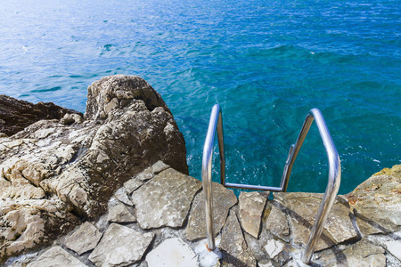 Wild stony sea beach of Croatia, Dubrovnik. Stairway to the water.の写真素材
