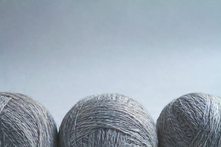 Three balls of wool, tinted craft background.