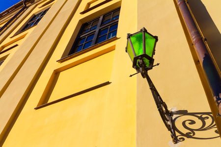 Old street lamp made of green glass hanging on a city wall. Europe architecture.の写真素材