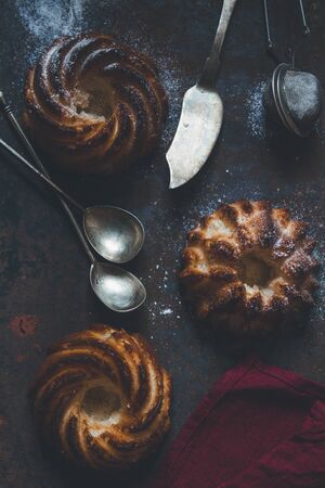 Fresh home made baked  pastries with a cutlery set, dark moodの写真素材