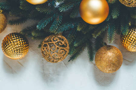 Christmas seasonal background glowing, fir tree branch with decorationsの写真素材