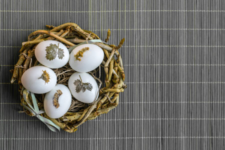 Easter eggs in the nest on the grey background
