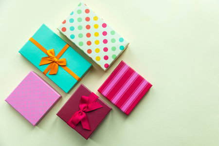 Holidays giftboxes on the pastel yellow background for mother's day, christmas, birthdayの写真素材
