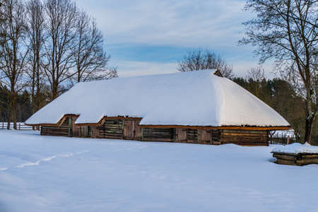 Traditional Wooden Barn or Hut in the Winter Dayの写真素材