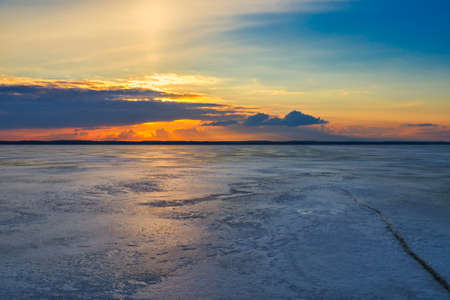 Beautiful Colorful Winter Landscape with Frozen Lake and Sunset skyの写真素材