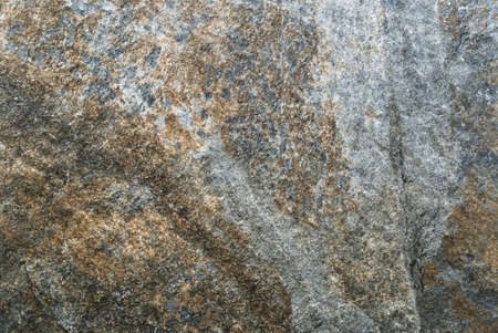 Texture of the Old Stone Wall Covered with Mossの写真素材