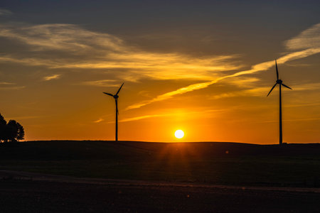 Beautiful Sunset with Silhouettes of Wind Power Plants