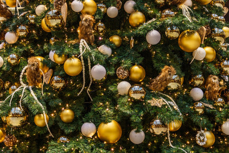 big Christmas tree decorated with balls, lights, and toys