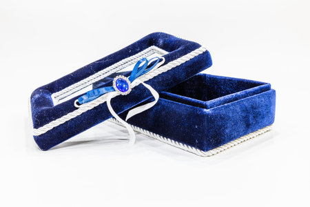 open jewelry or gift box with a ribbon isolated on a white background