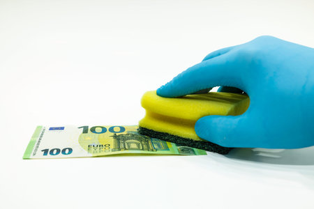 100 Euro money banknote, gloves, and sponge. The concept of money laundering ALMの写真素材