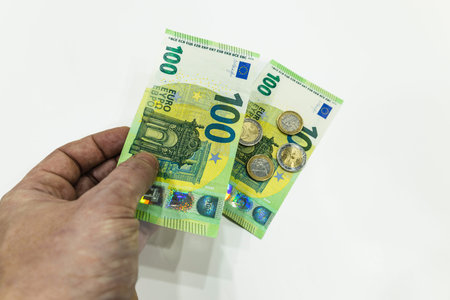 Male hand holding 100 Euro bill. Money saving concept