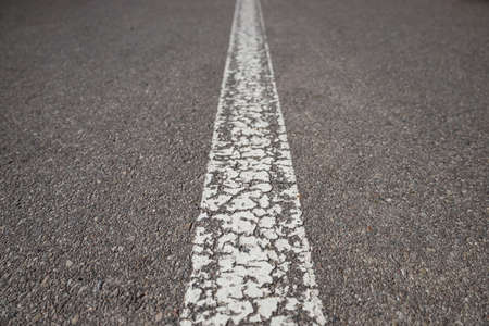 Asphalt road with single solid white line road markingの写真素材