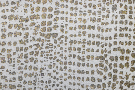 Fragment of fabric tapestry wallpaper with golden glossy pattern and textures.