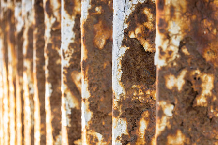 Rusty bridge railing texture background with cracked white paint.