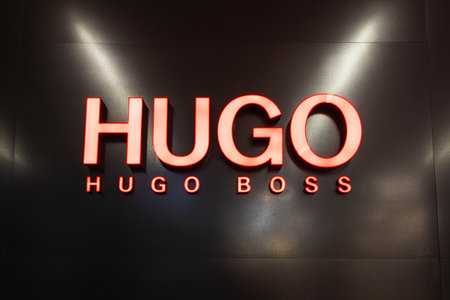 Logotype logo sign of Hugo Boss on the wall of the store. Kaunas, Lithuania, 22 June 2022.のeditorial素材
