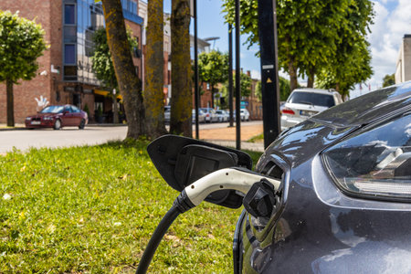 Electric vehicle or EV car with the power cable supply plugged in.の写真素材