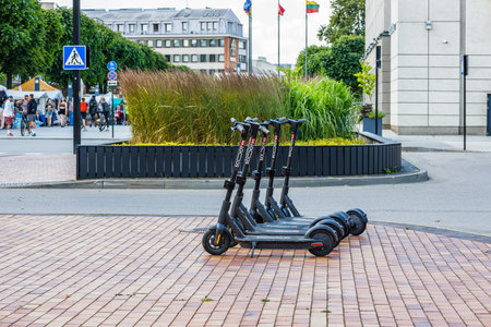 Electric scooters for public share standing outside in city center. Alytus, Lithuania, 14 July 2022.のeditorial素材
