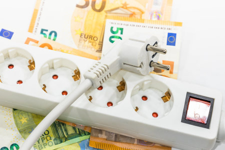 Outlet extension socket and euro banknotes. Concept of rising electricity prices.の写真素材