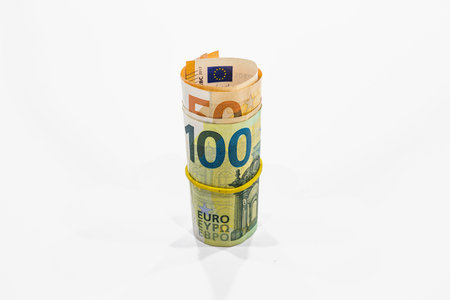 Roll of Euro notes in the elastic band. EU banknotes in a money roll. Organized crime concept.の写真素材