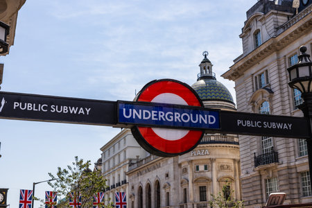 London Underground Sign at Public Subway Entrance with Historic Buildingsの写真素材