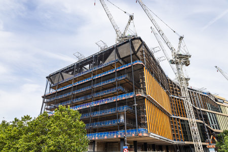 Modern Building Under Construction with Cranes in London, Urban Development Scene