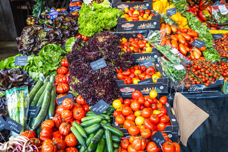 Fresh Vegetable Stall with Organic Tomatoes and Greens at Borough Market, London, UK