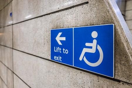 Wheelchair Accessibility Sign with Arrow to Lift in Underground Stationの写真素材