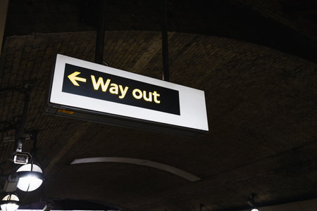London Underground Station - Way Out - Sign Illuminated in Dark Tunnel Environmentの写真素材