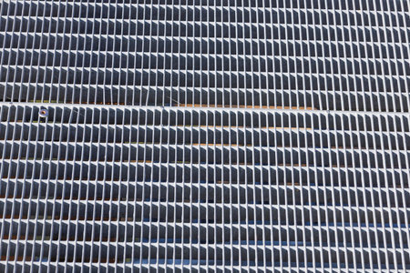 Closeup of Metallic Ventilation Grille with Repetitive Horizontal Slats Abstract Texture