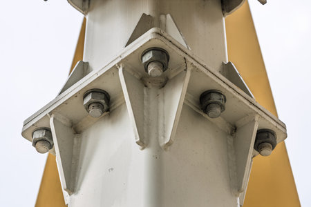 Bolted gusset plate on structural steel column with yellow beam, engineering close upの写真素材