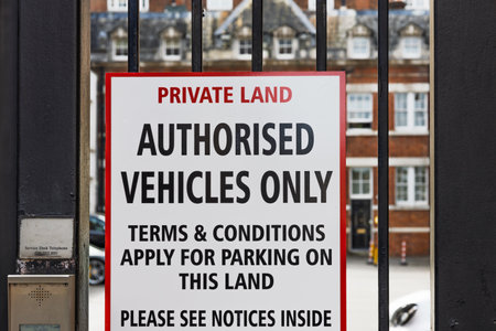 Private Land Sign on Black Iron Gate. Authorised Vehicles Only, Parking Terms Applyの写真素材