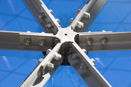 High strength structural steel connection with bolts forming X node under transparent roofの写真素材