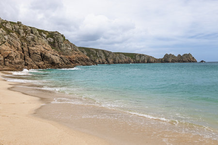 Porthcurno Beach, Cornwall UK with wide golden sand and clear Atlantic waterの写真素材