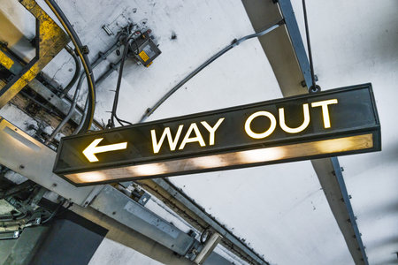 Way Out Exit Sign with Left Arrow in Underground Metro Stationの写真素材