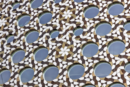 Geometric Islamic Lattice Facade with Circular Openings and Star Arabesque Pattern Detail