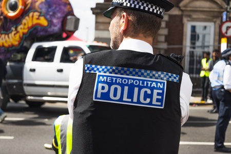 UK Metropolitan Police Uniformed Officer Managing Crowd