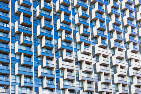 Modern apartment facade with repetitive balconies and windows pattern
