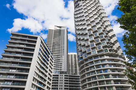 Curved balcony skyscrapers with glass facades define a modern residential city skylineの写真素材