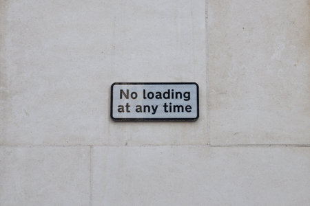 No Loading at Any Time Sign on Light Stone Wallの写真素材