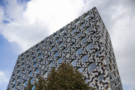 Parametric geometric facade on contemporary building, low angle urban architecture