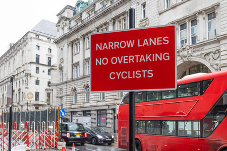 London Road Safety Sign Narrow Lanes No Overtaking Cyclists. London, UK, 10 December 2023のeditorial素材