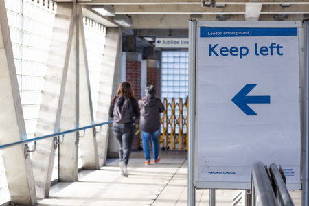 Keep Left Sign with Blue Arrow Directing Pedestrians in Urban Walkway