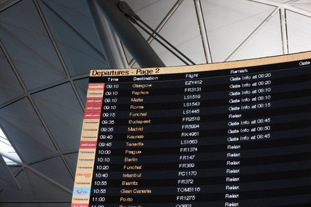 Digital airport flight status screen showing departures and gate times. London, UK, 11 November 2024のeditorial素材