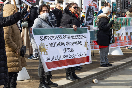Protesters holding sign supporting Iranian womens movement. London, UK, 11 March 2023