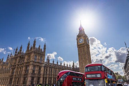 Red double-decker bus passing Big Ben. London, UK, 9 July 2023