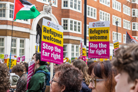 Protesters hold refugees welcome signs at a public demonstration. London, UK, 16 March 2024