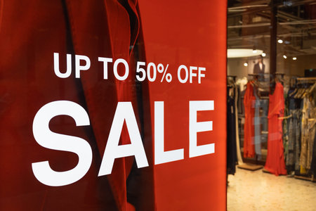 Red sale sign in front of a clothing retail store