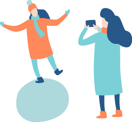 Woman with smartphone taking picture of her female friend balancing on a snowball, both wearing winter clothes, simple flat vector illustrationのイラスト素材