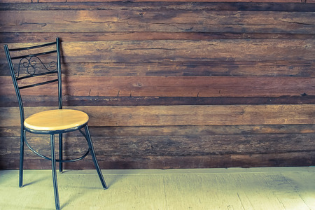 chair in an empty room with wooden floor and backgroundvintageの写真素材